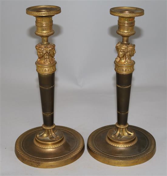 A pair of Empire style bronzed ormolu candlesticks, 10.5in.